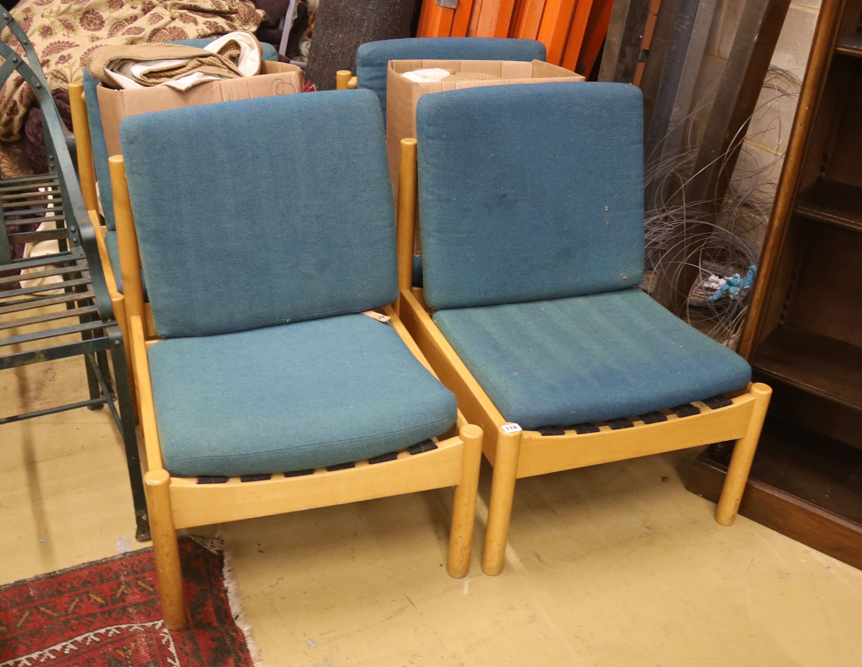 A set of four Ercol pale beech lounge chairs with cushion seats and backs, width 60cm, depth 66cm, height 82cm